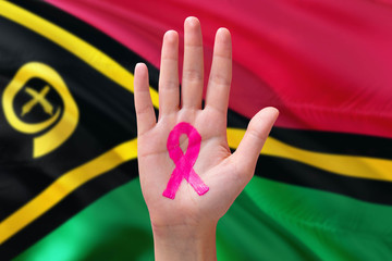 Vanuatu awareness concept. Close-up awareness ribbon painted on palm on national flag background....