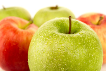 selective focus of green ripe wet apple isolated on white