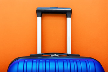 Modern Phantom Blue classic blue suitcase on Lush Lava background close up copy space for text....