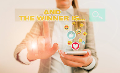 Conceptual hand writing showing And The Winner Is. Concept meaning announcing a demonstrating or...