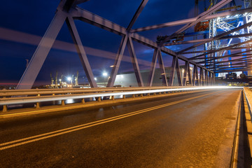 Fototapeta na wymiar night traffic lights inside of steel bridge