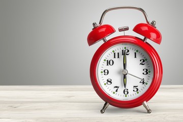 Retro classic alarm clock on background