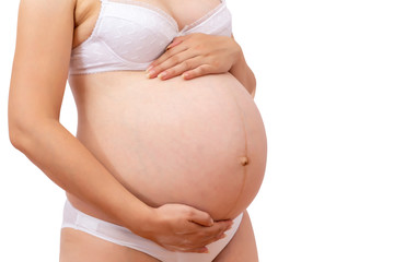 Cropped view of pregnant woman in underwear holding her belly