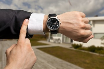 Fashion Businessman with at luxury watch. Checking the time concept.