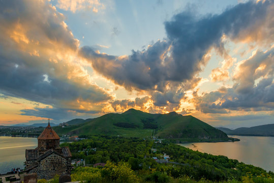 Dramatic beautiful sky at sunset over Sevan, view of Sevanavank Monastery, Armenian landmark
