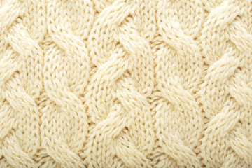 Beige knitted fabric wool texture for background. Close up of White Knitted material pattern for design. Beige warm sweater textile background.