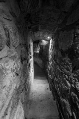 Narrow passage inside the fortress wall. Black and white.