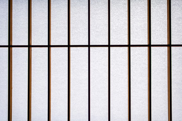 Macro closeup of white shoji sliding paper doors closed in traditional japanese house or ryokan abstract pattern