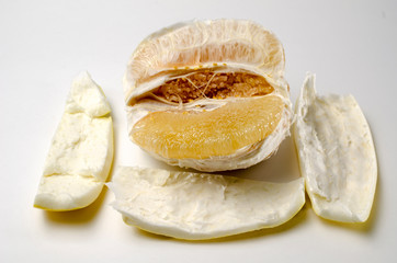 freshly peeled pamelo on a white background
