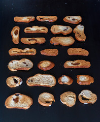 Wheat rusks on a wooden dark background.