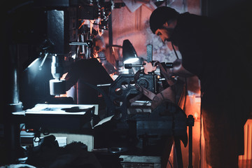 At the cozy studio a leather designer is working on his new project.