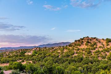 Sunset pink twilight in Santa Fe, New Mexico Tesuque community neighborhood with houses green...