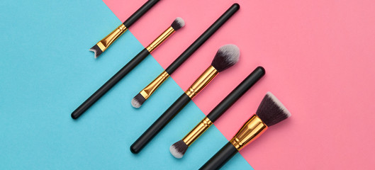 Fashion cosmetic makeup Set. Minimal. Beauty product on pink blue background. Trendy accessories, cosmetics, brushes art fashionable Flat lay. Creative colorful make up concept, banner