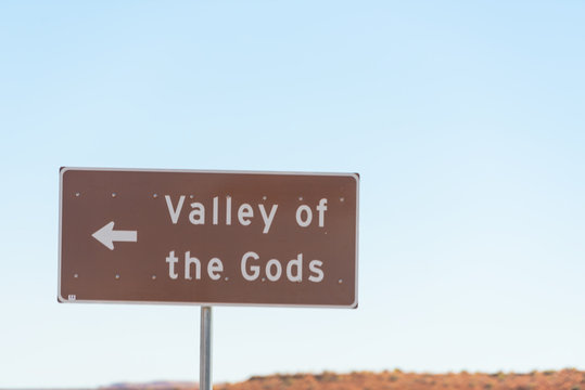 Closeup of sign for famous valley of the gods near Monument Valley canyons in Utah with arrow direction sign