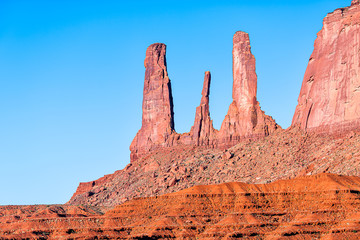Closeup view of famous mesa butte three sisters formations with red orange rock color in Monument...