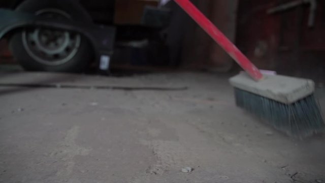 Man sweeping floor with broom