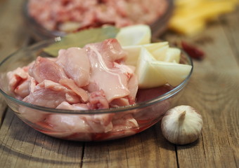 meat rabbit flesh, raw meat for minced meat for twisting through a meat grinder on a wooden ancient table