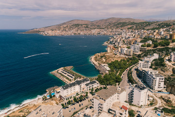 Fototapeta premium Aerial view - Sarande, The Capital of Albanian Riviera - drone shot - up point of view. The Mediteranean Sea and the city center in the background