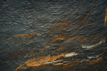 A dark abstract golden gray ore mineral Texture background