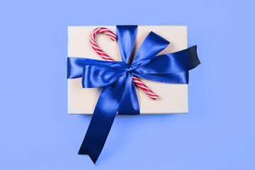 craft box with a trendy blue bow and red Christmas candy