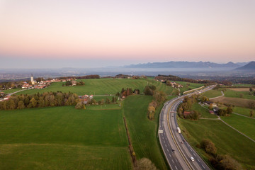 Fototapeta na wymiar Top down aerial view of freeway interstate road with moving traffic cars in rural area.