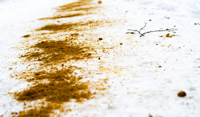 Fototapeta na wymiar The winter sidewalk is sprinkled with sand. Ice, injury. Sand in the snow. Sand in the macro on the snow. Safety.