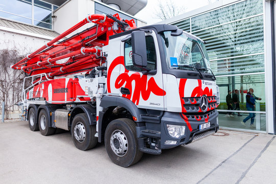 MUNICH / GERMANY - APRIL 14, 2019: Mercedes Benz truck with a concrete pump stands in front of a hall in Munich.