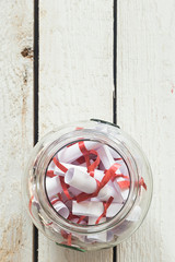 Valentine's day concept. Opened Date Jar with desires on wood