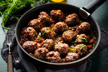 Fried meatballs with sauce on pan