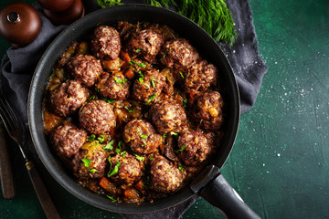 Fried meatballs with sauce on pan