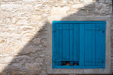 Fototapeta na wymiar The facade of a Cypriot village house with shutters.