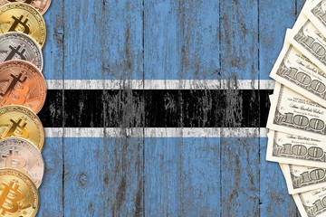Botswana savings concept. Bitcoins and dollar banknotes on the side of national flag with wooden background. Trading currencies.