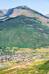 Fototapeta na wymiar High angle aerial vertical view of Silverton, Colorado small town from overlook during sunny day in summer with forest trees mountain peak