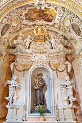 Fototapeta na wymiar OSSUCCIO, ITALY - MAY 12, 2015: The baroque side altar of st. Antohony of Padua in church Chiesa dei Santi Eufemia e Vicenzo.