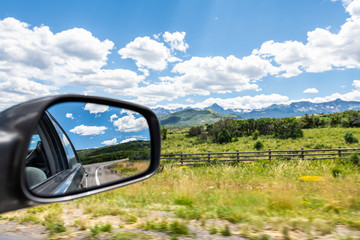 Obraz na płótnie Canvas Wide angle view near Ouray, Colorado highway scenic road 550 San Juan rocky mountains range with Ridgway countryside rural fence and rear view mirror