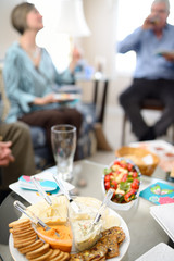 Woman and man talking and enjoying drinks and appetizers before a dinner party