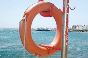 Look at the ship on the dock through the lifeline. The foreground is blurred
