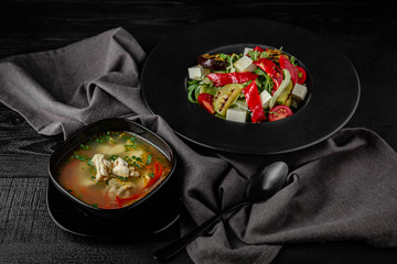 Grilled vegetable salad: zucchini, eggplant, bell peppers, herbs and feta cheese. Nutritious, dietary, fitness food. Black boards background