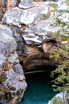 Independence Pass rocky mountain closeup view of grottos cave pool near scenic byway in morning near Aspen, Colorado after frozen snow