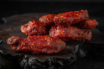 Spicy Wings on black background. Snack to beer. Fast food.