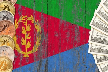 Eritrea savings concept. Bitcoins and dollar banknotes on the side of national flag with wooden background. Trading currencies.
