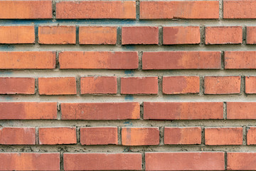 Obraz premium Wall texture of modern brown rough brick. Cross brickwork. Grunge surface background. Vintage orange brickwall.
