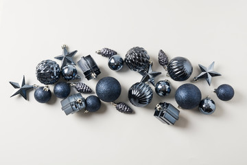 Christmas classic blue balls on neutral pastel grey. Top view. Xmas banner. Holiday greeting card. Trendy color of the 2020 Year.