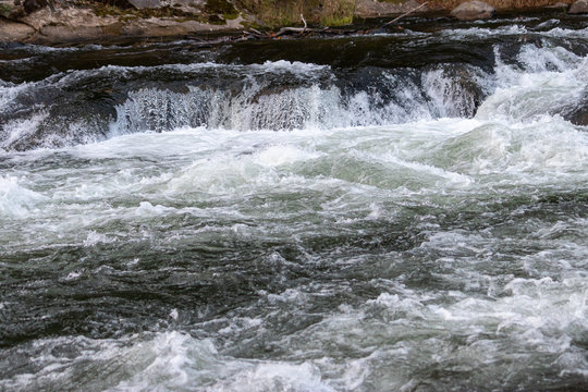 Small White Water Fall Into Rapids On Blue River