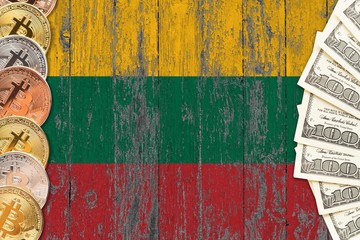 Lithuania savings concept. Bitcoins and dollar banknotes on the side of national flag with wooden background. Trading currencies.