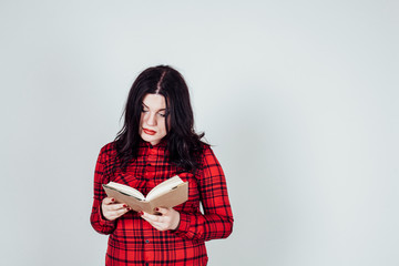 fat girl in a red shirt reads a book