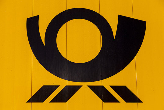 HANNOVER / GERMANY - NOVEMBER 27, 2016: german mail service ( Deutsche Post ) logo on a yellow container