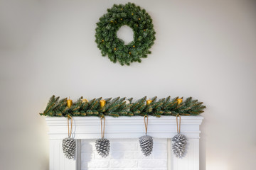 Fototapeta premium Fireplace with beautiful Christmas wreath, decorations in room