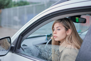 business girl in the car looking out the window