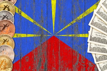 Reunion savings concept. Bitcoins and dollar banknotes on the side of national flag with wooden background. Trading currencies.
